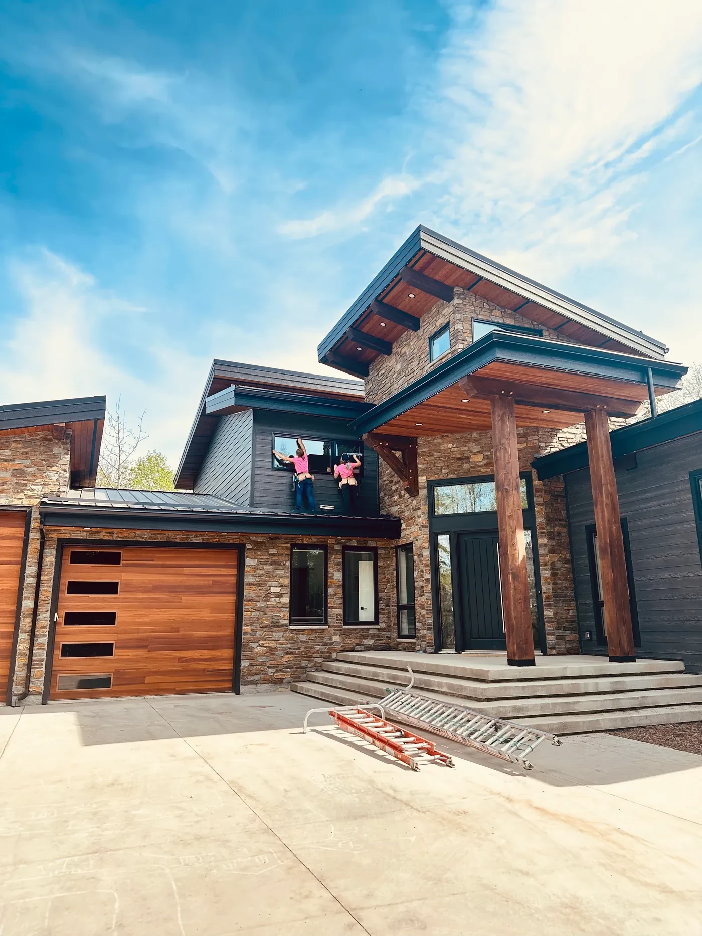 Peace Home Services team cleaning windows at a modern home near Grande Prairie